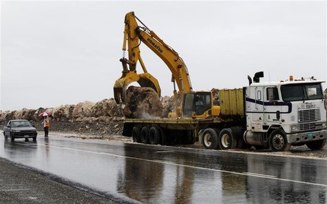 A crane operator lifts a boulder to be added to a seawall in preparation for the arrival of Tropical Storm Sandy, predicted to be a hurrican A crane operator lifts a boulder to be added to a seawall in preparation for the arrival of Tropical Storm Sandy, predicted to be a hurrican