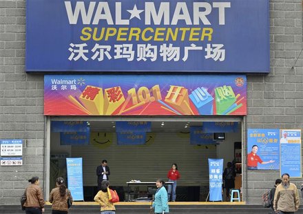 Employees stand in front of the gate to a Wal-Mart Supercenter in Chongqing municipality October 24, 2011. REUTERS/Stringer Employees stand in front of the gate to a Wal-Mart Supercenter in Chongqing municipality October 24, 2011. REUTERS/Stringer