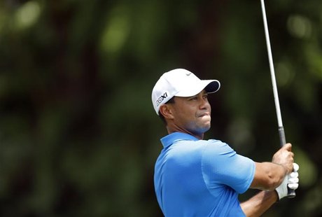 Tiger Woods of the U.S. watches his shot on the first hole during the Malaysia's Asia Pacific Classic golf tournament in Kuala Lumpur Octobe Tiger Woods of the U.S. watches his shot on the first hole during the Malaysia's Asia Pacific Classic golf tournament in Kuala Lumpur Octobe