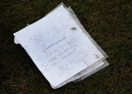 A card lays on the spot where the headstone was removed from the grave of British television star Jimmy Savile at a cemetery in Scarborough, A card lays on the spot where the headstone was removed from the grave of British television star Jimmy Savile at a cemetery in Scarborough,