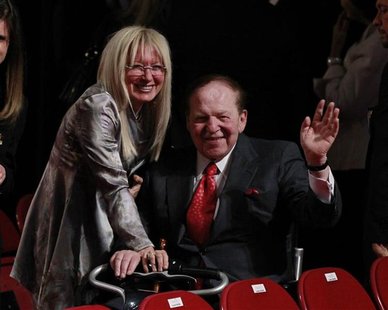 Chairman and CEO of the Las Vegas Sands casino Sheldon Adelson (C), a donor to Republican presidential nominee Mitt Romney, waves to photogr Chairman and CEO of the Las Vegas Sands casino Sheldon Adelson (C), a donor to Republican presidential nominee Mitt Romney, waves to photogr