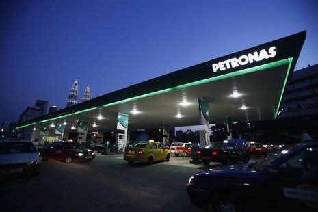 Motorists queue to fill natural gas at a Petronas station with its landmark Petronas Twin Towers headquarters in the background, in Kuala Lu Motorists queue to fill natural gas at a Petronas station with its landmark Petronas Twin Towers headquarters in the background, in Kuala Lu