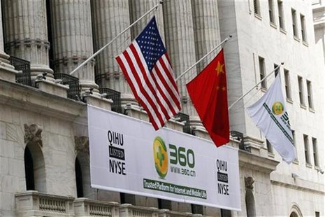A sign advertising the Qihoo 360 Technology Co Ltd is hung with the U.S. and Chinese flags outside of the New York Stock Exchange before the A sign advertising the Qihoo 360 Technology Co Ltd is hung with the U.S. and Chinese flags outside of the New York Stock Exchange before the
