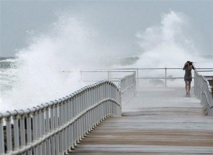 Jean Marie Brennan walks along the jetty at Lighthouse Point Park as Hurricane Sandy passes offshore in Ponce Inlet, Florida, October 26, 20 Jean Marie Brennan walks along the jetty at Lighthouse Point Park as Hurricane Sandy passes offshore in Ponce Inlet, Florida, October 26, 20