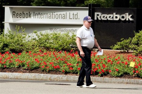 A security guard walks outside the world headquarters for Reebok in Canton, Massachusetts August 3, 2005. REUTERS/Brian Snyder A security guard walks outside the world headquarters for Reebok in Canton, Massachusetts August 3, 2005. REUTERS/Brian Snyder