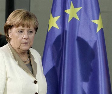 German Chancellor Angela Merkel casts her shadow on an European Union (EU) flag as she arrives for a news conference after talks with Yemen' German Chancellor Angela Merkel casts her shadow on an European Union (EU) flag as she arrives for a news conference after talks with Yemen'