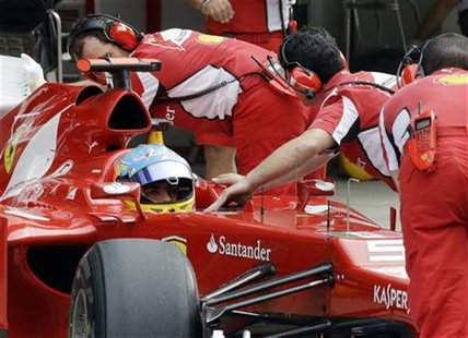 Ferrari Formula One driver Fernando Alonso of Spain is pushed into his garage during the qualifying session of the Indian F1 Grand Prix at t Ferrari Formula One driver Fernando Alonso of Spain is pushed into his garage during the qualifying session of the Indian F1 Grand Prix at t