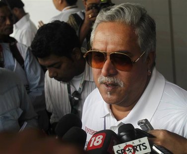 Force India team principal Vijay Mallya talks to the media in the paddock during the third practice session of the Indian F1 Grand Prix at t Force India team principal Vijay Mallya talks to the media in the paddock during the third practice session of the Indian F1 Grand Prix at t