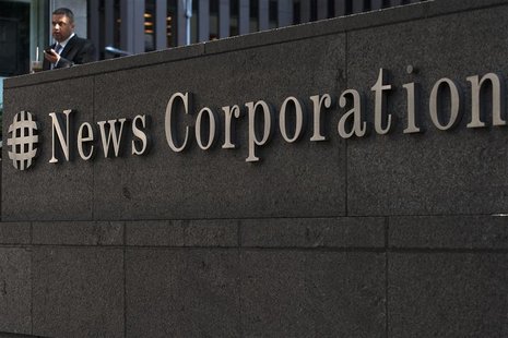 A passer-by stands in front of the News Corporation building in New York June 28, 2012. REUTERS/Keith Bedford A passer-by stands in front of the News Corporation building in New York June 28, 2012. REUTERS/Keith Bedford