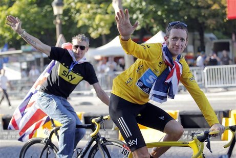 Sky Procycling rider and leader's yellow jersey Bradley Wiggins of Britain and Sky Procycling Sport director Sean Yates (L) celebrate with B Sky Procycling rider and leader's yellow jersey Bradley Wiggins of Britain and Sky Procycling Sport director Sean Yates (L) celebrate with B