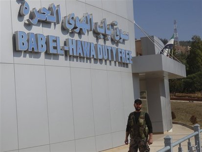 A member of the Free Syrian Army stands guard at Bab El-Hawa duty free shopping centre on the outskirts of Idlib, near the Syria-Turkey bord A member of the Free Syrian Army stands guard at Bab El-Hawa duty free shopping centre on the outskirts of Idlib, near the Syria-Turkey bord