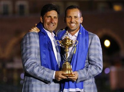 Team Europe golfer Sergio Garcia (R) of Spain holds the Ryder Cup with captain Jose Maria Olazabal after the closing ceremony of the 39th Ry Team Europe golfer Sergio Garcia (R) of Spain holds the Ryder Cup with captain Jose Maria Olazabal after the closing ceremony of the 39th Ry