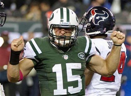 New York Jets quarterback Tim Tebow celebrates running for a first down against the Houston Texans in the fourth quarter of their NFL footba New York Jets quarterback Tim Tebow celebrates running for a first down against the Houston Texans in the fourth quarter of their NFL footba