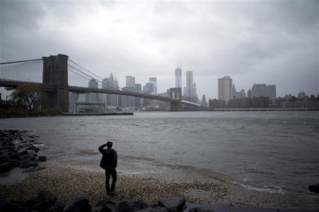 A man watches rising waters on the East River from Brooklyn as Hurricane Sandy made its approach in New York October 29, 2012. REUTERS/Andre A man watches rising waters on the East River from Brooklyn as Hurricane Sandy made its approach in New York October 29, 2012. REUTERS/Andre