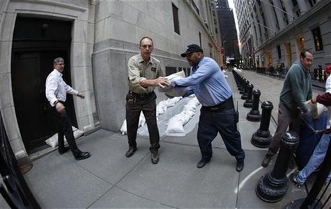 New York Stock Exchange workers place sand bags in front of doors and over electrical vaults at the exchange in New York October 28, 2012. R New York Stock Exchange workers place sand bags in front of doors and over electrical vaults at the exchange in New York October 28, 2012. R