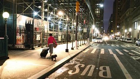 A woman with her luggage and a dog make their way to Wall Street station, to get out of lower Manhattan in New York October 28, 2012. REUTER A woman with her luggage and a dog make their way to Wall Street station, to get out of lower Manhattan in New York October 28, 2012. REUTER