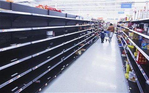 A woman and child walk through an aisle, emptied in preparation for Hurricane Sandy, in a Wal-Mart store in Riverhead, New York, October 28, A woman and child walk through an aisle, emptied in preparation for Hurricane Sandy, in a Wal-Mart store in Riverhead, New York, October 28,