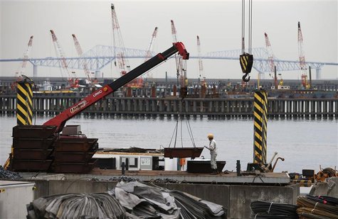 A man works in front of cranes at an industrial area in Tokyo October 30, 2012. REUTERS/Toru Hanai A man works in front of cranes at an industrial area in Tokyo October 30, 2012. REUTERS/Toru Hanai