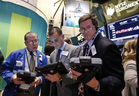 Traders work in front of a trading board showing Shutterstock Inc on the floor of the New York Stock Exchange, October 11, 2012. REUTERS/Bre Traders work in front of a trading board showing Shutterstock Inc on the floor of the New York Stock Exchange, October 11, 2012. REUTERS/Bre