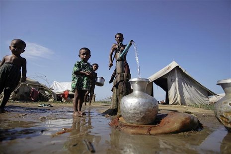 People collect water at a refugee camp for Muslims displaced by violence earlier this year outside Sittwe October 30, 2012. REUTERS/Soe Zeya People collect water at a refugee camp for Muslims displaced by violence earlier this year outside Sittwe October 30, 2012. REUTERS/Soe Zeya