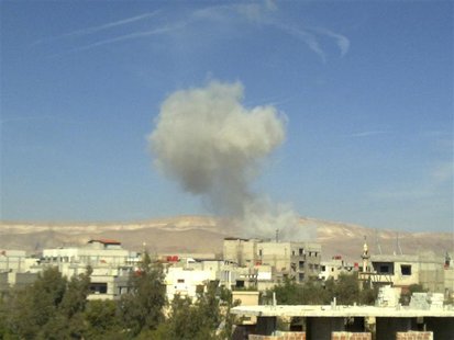 Smoke rises from what activists say was a missile fired by a Syrian Air Force fighter jet loyal to Syria's President Bashar al-Assad at Erbe Smoke rises from what activists say was a missile fired by a Syrian Air Force fighter jet loyal to Syria's President Bashar al-Assad at Erbe