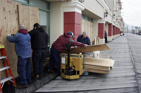 A crew from the Tropicana Casino removes plywood sheets from the windows facing the ocean on the boardwalk following the aftermath of Hurric A crew from the Tropicana Casino removes plywood sheets from the windows facing the ocean on the boardwalk following the aftermath of Hurric