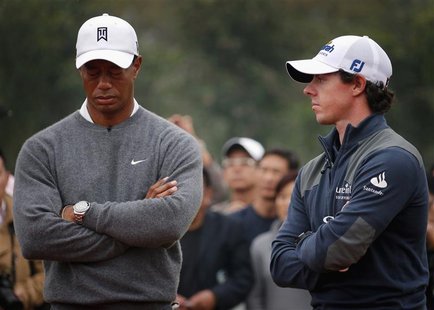 Tiger Woods (L) of the U.S. reacts as he stands next to fellow golfer Rory McIlroy of Northern Ireland during the trophy presentation after Tiger Woods (L) of the U.S. reacts as he stands next to fellow golfer Rory McIlroy of Northern Ireland during the trophy presentation after