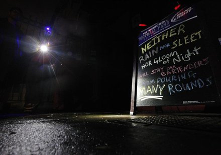 Devin Vilardi, Manager, stands with a flash light outside Professor Thom's bar that is still serving drinks even though they have no power i Devin Vilardi, Manager, stands with a flash light outside Professor Thom's bar that is still serving drinks even though they have no power i