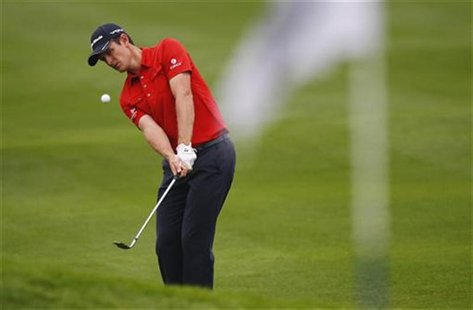 Justin Rose of England hits a shot on the 15th hole during the BMW Masters 2012 golf tournament at Lake Malaren Golf Club in Shanghai, Octob Justin Rose of England hits a shot on the 15th hole during the BMW Masters 2012 golf tournament at Lake Malaren Golf Club in Shanghai, Octob