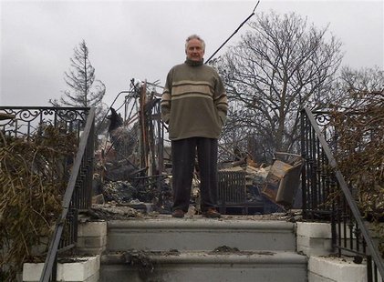 Bruce Bavasso stands in front of what is left of his home in the Belle Harbor neighborhood of New York, October 30, 2012. Bavasso's three-st Bruce Bavasso stands in front of what is left of his home in the Belle Harbor neighborhood of New York, October 30, 2012. Bavasso's three-st