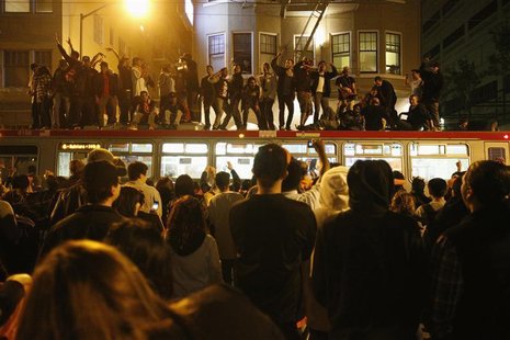 Baseball fans jump on a bus in celebration at Civic Center Plaza after the San Francisco Giants defeated the Detroit Tigers, winning the MLB Baseball fans jump on a bus in celebration at Civic Center Plaza after the San Francisco Giants defeated the Detroit Tigers, winning the MLB