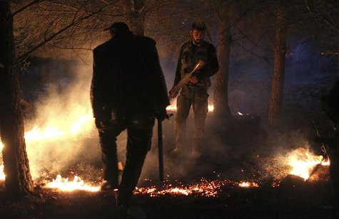 Members of the Free Syrian Army set up a fire to obscure the Kurdish militants' vision, while standing alert during a truce on the top of a Members of the Free Syrian Army set up a fire to obscure the Kurdish militants' vision, while standing alert during a truce on the top of a