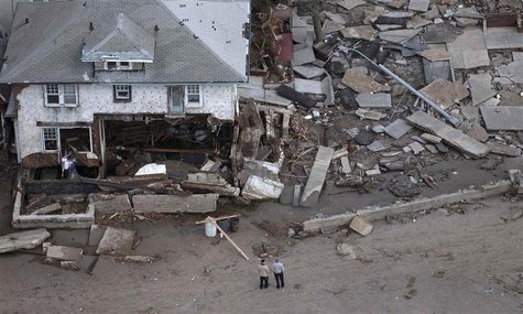 Men stand near a destroyed home in Seagate, New York on October 31, 2012. REUTERS/Adrees Latif Men stand near a destroyed home in Seagate, New York on October 31, 2012. REUTERS/Adrees Latif