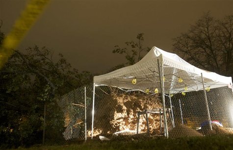 A tent protects the skeletal remains of at least two individuals which were unearthed when a 100-year-old oak tree fell on the Green in New A tent protects the skeletal remains of at least two individuals which were unearthed when a 100-year-old oak tree fell on the Green in New