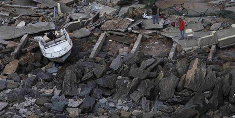 Men stand near a boat which was pushed inland near destroyed homes in Brighton, New York on October 31, 2012. REUTERS/Adrees Latif Men stand near a boat which was pushed inland near destroyed homes in Brighton, New York on October 31, 2012. REUTERS/Adrees Latif
