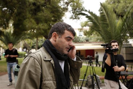 Greek editor Costas Vaxevanis speaks on the phone outside a courthouse in Athens November 1, 2012. REUTERS/Yorgos Karahalis Greek editor Costas Vaxevanis speaks on the phone outside a courthouse in Athens November 1, 2012. REUTERS/Yorgos Karahalis