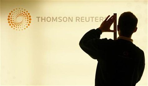 A worker unveils a lightbox displaying the new logo on a Thomson Reuters screen at their headquarters in London's Canary Wharf district earl A worker unveils a lightbox displaying the new logo on a Thomson Reuters screen at their headquarters in London's Canary Wharf district earl