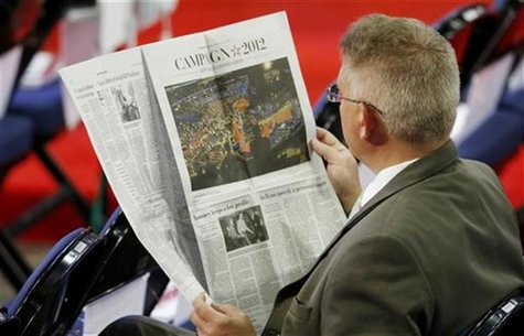 A man on the floor of the convention reads The Washington Post before the start of the second session of the Republican National Convention A man on the floor of the convention reads The Washington Post before the start of the second session of the Republican National Convention