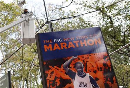 A worker is seen in a bucket truck in front of a sign for the New York City Marathon in the aftermath of Hurricane Sandy in New York November 2, 2012. REUTERS/Carlo Allegri A worker is seen in a bucket truck in front of a sign for the New York City Marathon in the aftermath of Hurricane Sandy in New York November 2, 2012. REUTERS/Carlo Allegri
