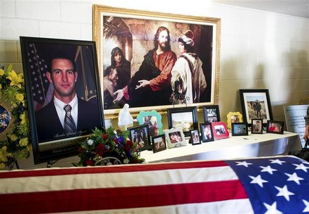 A portrait of U.S. Border Patrol agent Nicholas Ivie, 30, stands next to his flag-drapped coffin before his funeral in Sierra Vista, Arizona A portrait of U.S. Border Patrol agent Nicholas Ivie, 30, stands next to his flag-drapped coffin before his funeral in Sierra Vista, Arizona