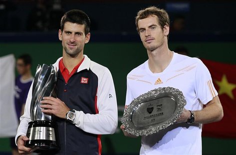Novak Djokovic (L) of Serbia stands next to Andy Murray of Britain during the trophy presentation after their men's singles final at the Sha Novak Djokovic (L) of Serbia stands next to Andy Murray of Britain during the trophy presentation after their men's singles final at the Sha