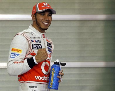 McLaren Formula One driver Lewis Hamilton of Britain celebrates after taking pole position in the qualifying session of the Abu Dhabi F1 Gra McLaren Formula One driver Lewis Hamilton of Britain celebrates after taking pole position in the qualifying session of the Abu Dhabi F1 Gra