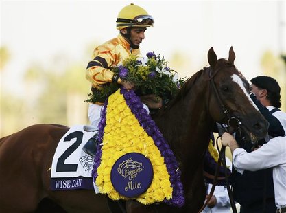 Jockey John Velazquez celebrates aboard horse Wise Dan after his first place win in the running of the Breeders' Cup Mile thoroughbred horse Jockey John Velazquez celebrates aboard horse Wise Dan after his first place win in the running of the Breeders' Cup Mile thoroughbred horse