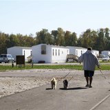 Jason Calvin walks his dogs in Joplin, Missouri October 20, 2012 at the FEMA mobile home park where he lives. An affordable place to live in Jason Calvin walks his dogs in Joplin, Missouri October 20, 2012 at the FEMA mobile home park where he lives. An affordable place to live in