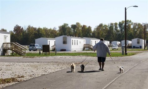 Jason Calvin walks his dogs in Joplin, Missouri October 20, 2012 at the FEMA mobile home park where he lives. An affordable place to live in Jason Calvin walks his dogs in Joplin, Missouri October 20, 2012 at the FEMA mobile home park where he lives. An affordable place to live in