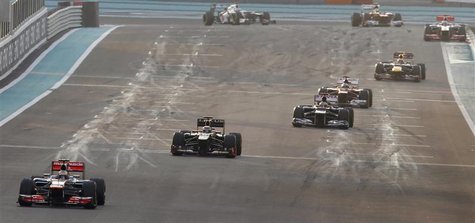 McLaren Formula One driver Lewis Hamilton (L) of Britain leads the pack at the start of the the Abu Dhabi F1 Grand Prix at the Yas Marina ci McLaren Formula One driver Lewis Hamilton (L) of Britain leads the pack at the start of the the Abu Dhabi F1 Grand Prix at the Yas Marina ci