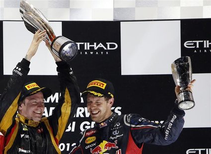 Lotus F1 Formula One driver Kimi Raikkonen of Finland and Red Bull Formula One driver Sebastian Vettel of Germany llift their trophies after Lotus F1 Formula One driver Kimi Raikkonen of Finland and Red Bull Formula One driver Sebastian Vettel of Germany llift their trophies after