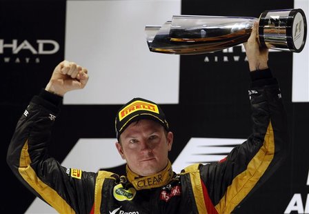 Lotus F1 Formula One driver Kimi Raikkonen of Finland lifts his trophy after winning the Abu Dhabi F1 Grand Prix at the Yas Marina circuit o Lotus F1 Formula One driver Kimi Raikkonen of Finland lifts his trophy after winning the Abu Dhabi F1 Grand Prix at the Yas Marina circuit o