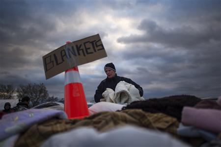 A victim of hurricane Sandy takes blankets from a aid distribution site in the Staten Island borough of New York November 3, 2012. Fuel supplies headed toward disaster zones in the U.S. Northeast on Saturday and a million customers regained electricity as near freezing temperatures threatened to add to the misery of coastal communities devastated by superstorm Sandy. Credit: Reuters/Adrees Latif A victim of hurricane Sandy takes blankets from a aid distribution site in the Staten Island borough of New York November 3, 2012. Fuel supplies headed toward disaster zones in the U.S. Northeast on Saturday and a million customers regained electricity as near freezing temperatures threatened to add to the misery of coastal communities devastated by superstorm Sandy. Credit: Reuters/Adrees Latif