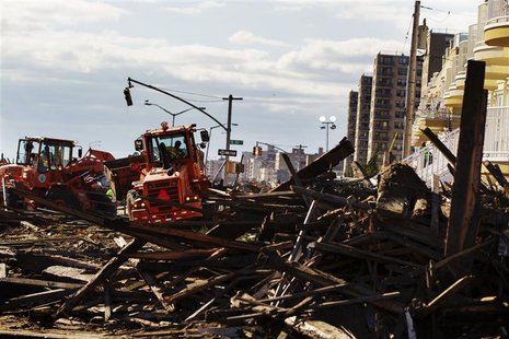 Department of Sanitation trucks work to clean up destroyed sections of boardwalk ripped apart by superstorm Sandy along Shore Front Parkway Department of Sanitation trucks work to clean up destroyed sections of boardwalk ripped apart by superstorm Sandy along Shore Front Parkway